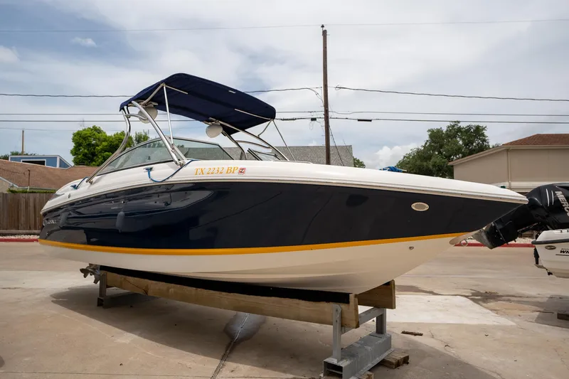 Slide: The Image of 2011 Cobalt 242 boat on a trailer in a residential area. - 4