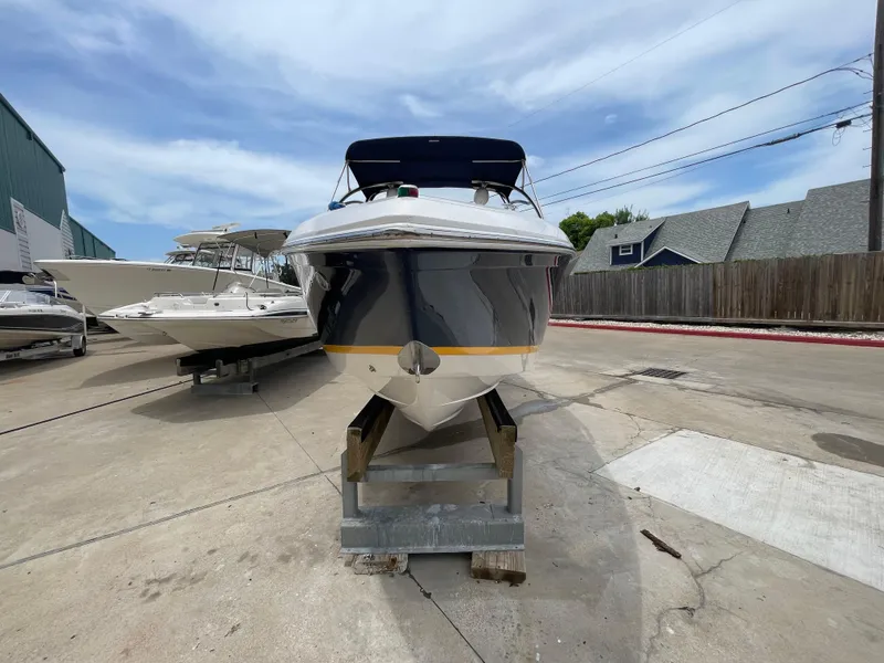Slide: The Image of 2011 Cobalt 242 boat on a stand in a marina. - 42