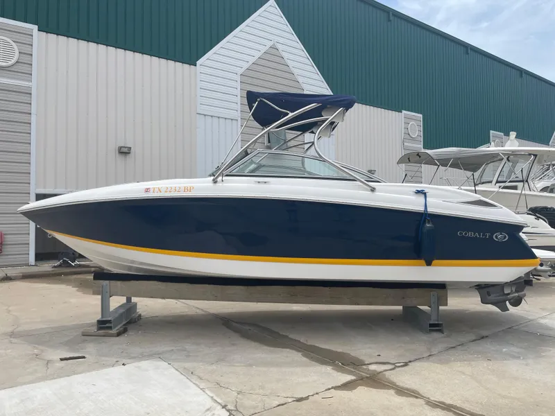 Slide: The Image of 2011 Cobalt 242 boat on a stand outside a storage facility. - 47