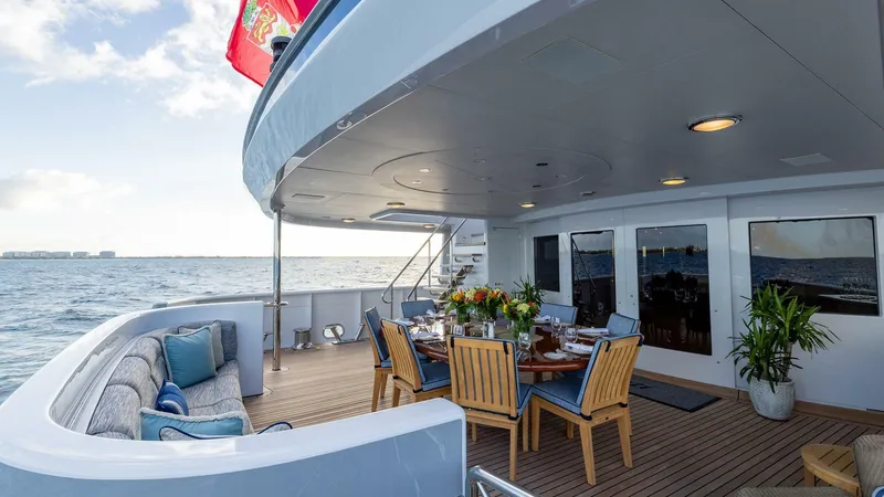 Slide: The Image of Luxury deck of 2003 Feadship 51.8M yacht with dining area and ocean view. - 16