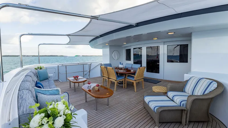 Slide: The Image of Luxurious deck of 2003 Feadship 51.8M yacht with seating and dining area. - 18