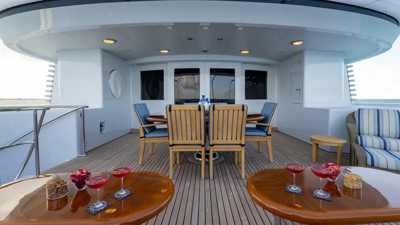 Slide: The Image of Luxury deck of 2003 Feadship 51.8M yacht with outdoor dining area and refreshments. - 19