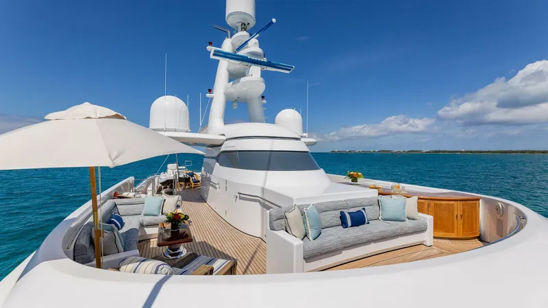 Slide: The Image of Luxurious 2003 Feadship 51.8M yacht with elegant outdoor seating and ocean view. - 23