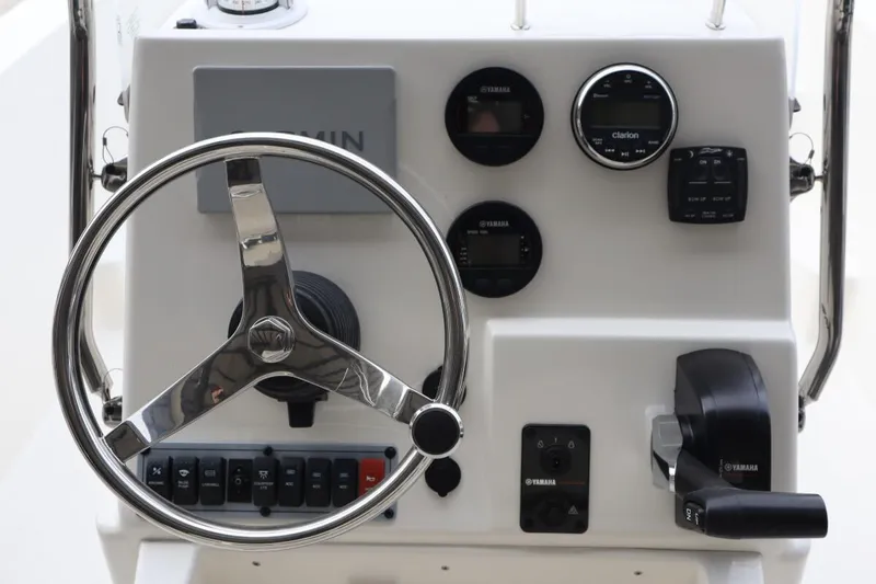 Slide: The Image of 2024 Key West 179FS boat console with steering wheel, Yamaha controls, and Garmin display. - 10