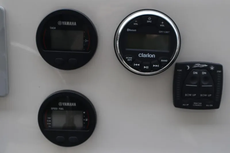 Slide: The Image of Close-up of 2024 Key West 179FS boat dashboard with Yamaha gauges and Clarion audio system. - 11
