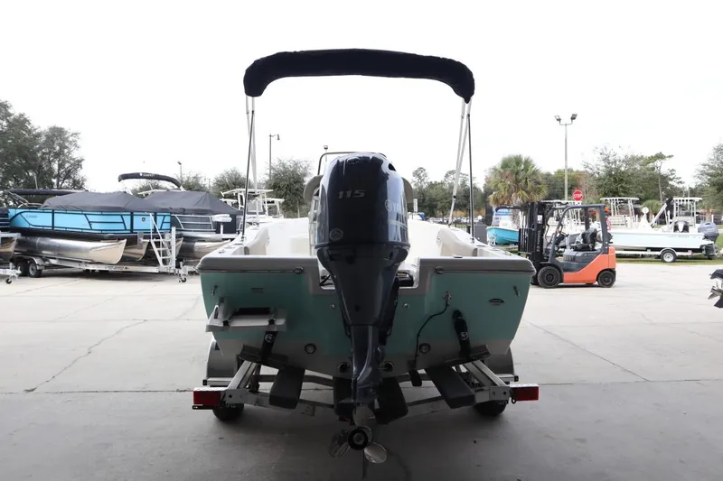 Slide: The Image of 2024 Key West 179FS boat with Yamaha 115 engine, rear view in a marina. - 5