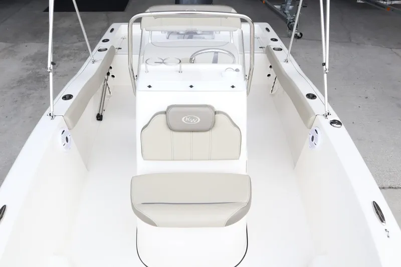 Slide: The Image of 2024 Key West 179FS boat interior with beige seating and console. - 7