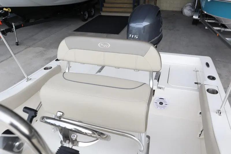 Slide: The Image of 2024 Key West 179FS boat interior with seating and Yamaha 115 outboard motor. - 9