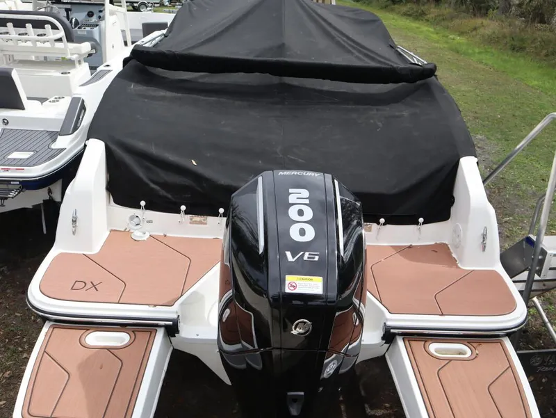 Slide: The Image of 2024 Bayliner DX2200 boat with Mercury 200 V6 engine, rear view. - 3