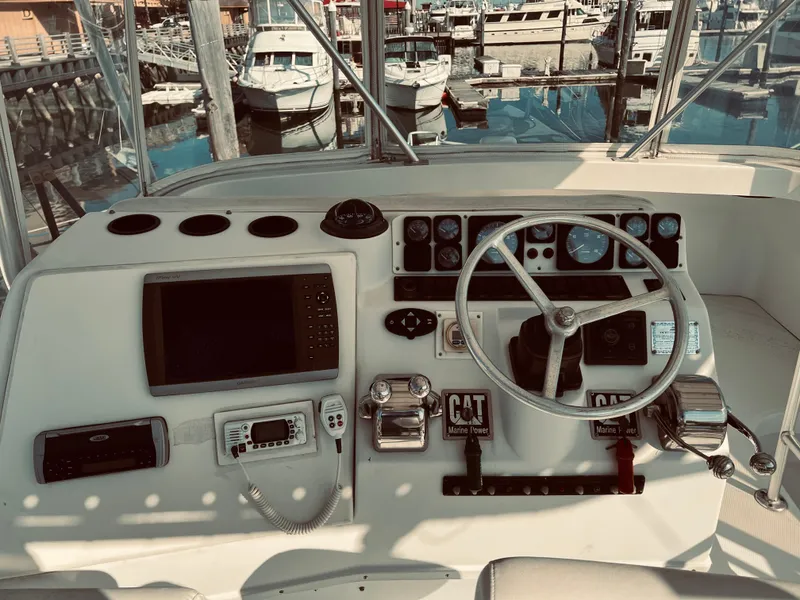 Slide: The Image of 1999 Luhrs 360 Sportfish helm with navigation equipment and steering wheel at marina. - 15