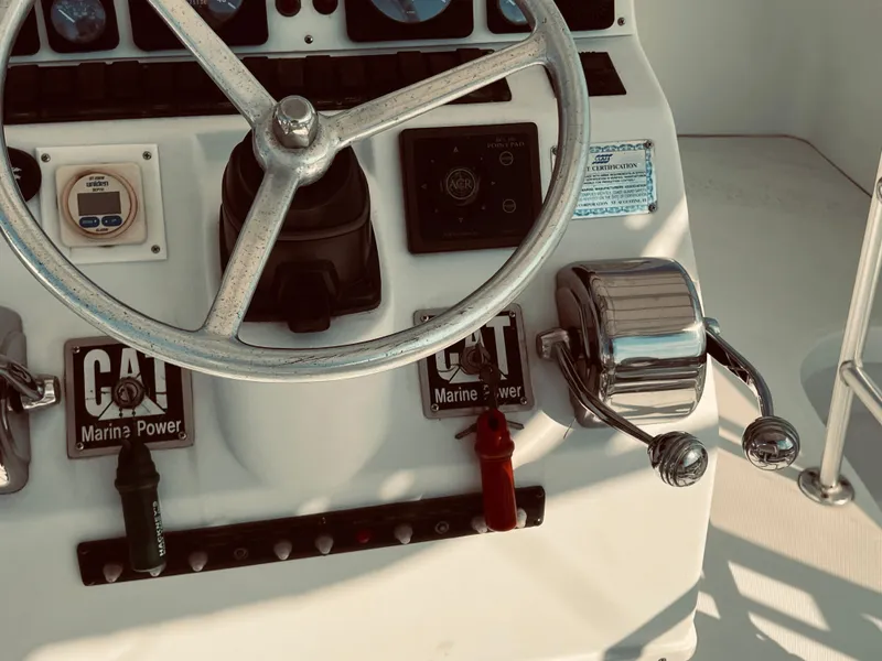 Slide: The Image of 1999 Luhrs 360 Sportfish boat helm with steering wheel and controls. - 17