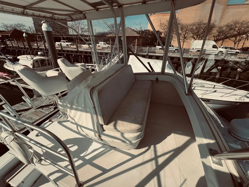 Slide: The Image of 1999 Luhrs 360 Sportfish boat interior with seating area and helm chairs. - 22