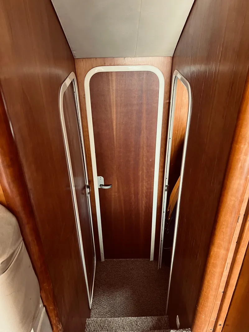 Slide: The Image of Interior hallway of a 1999 Luhrs 360 Sportfish boat with wooden door. - 28
