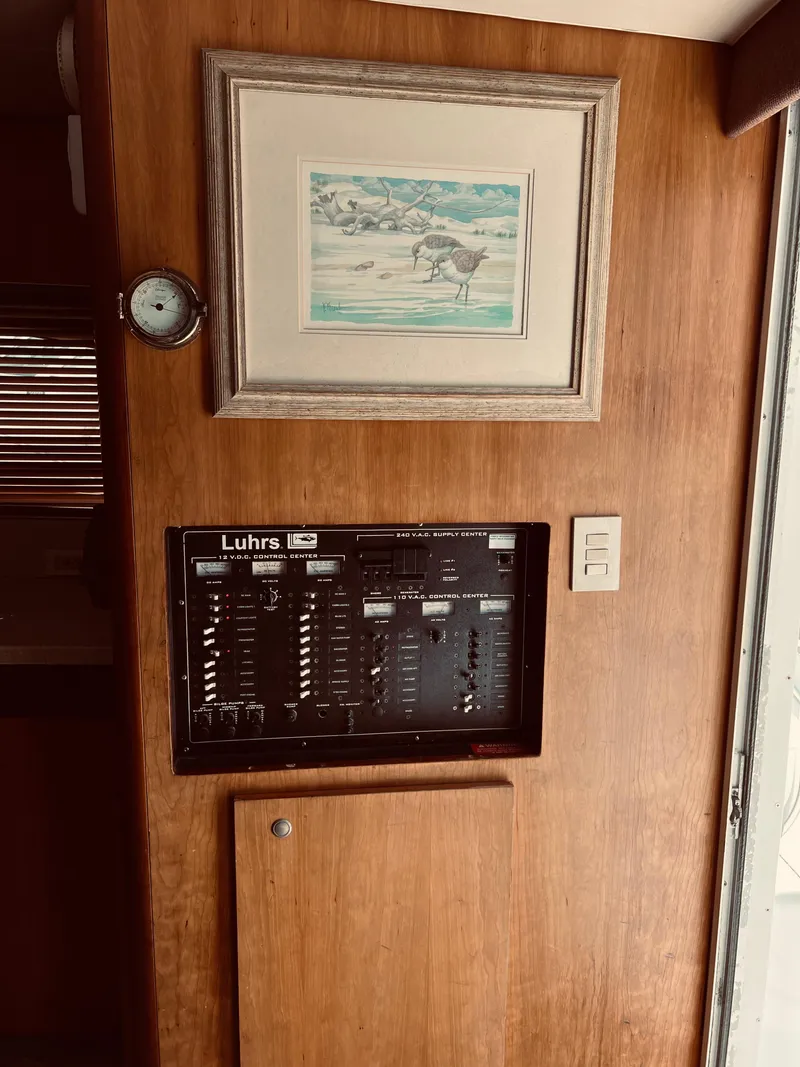 Slide: The Image of Electrical panel on 1999 Luhrs 360 Sportfish boat with framed artwork above. - 29