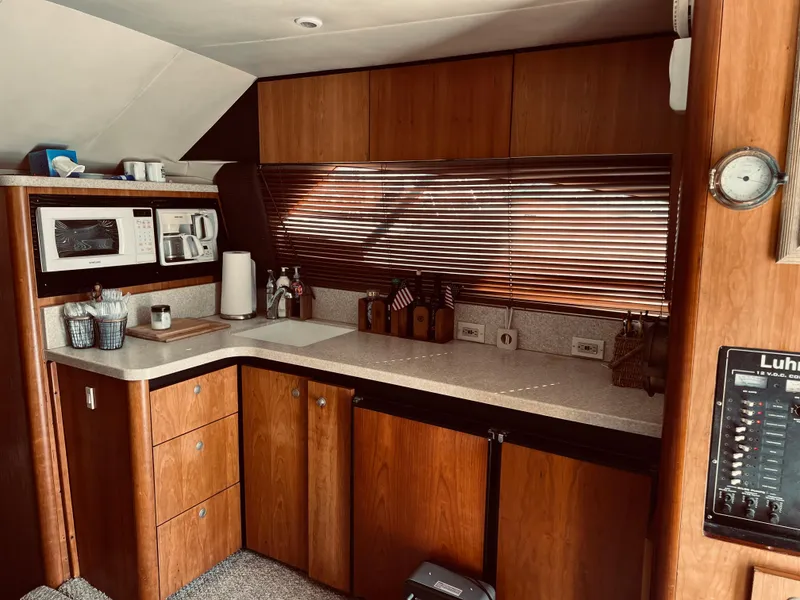 Slide: The Image of 1999 Luhrs 360 Sportfish kitchen with wooden cabinets and modern appliances - 30