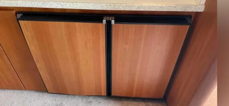 Slide: The Image of Wood-paneled refrigerator in 1999 Luhrs 360 Sportfish yacht kitchen. - 32