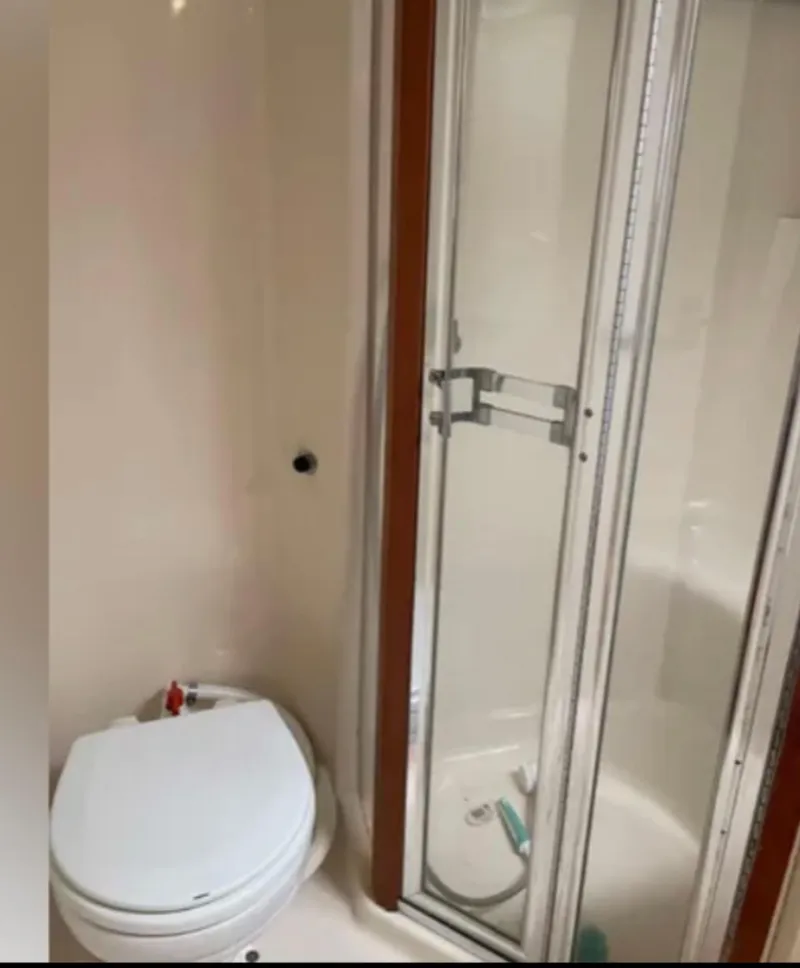 Slide: The Image of 1999 Luhrs 360 Sportfish bathroom with shower and toilet. - 35