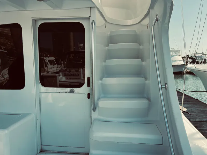 Slide: The Image of 1999 Luhrs 360 Sportfish boat with stairs and door to cabin. - 7