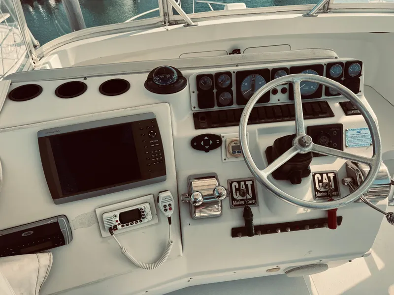 Slide: The Image of 1999 Luhrs 360 Sportfish helm with navigation and control instruments. - 8