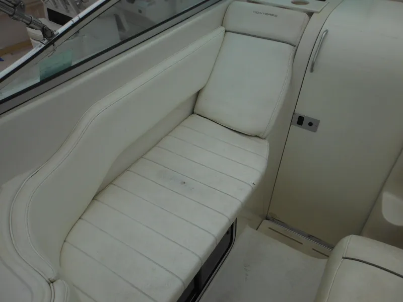 Slide: The Image of 1999 Monterey 262 Cruiser interior seating area with white upholstery. - 17