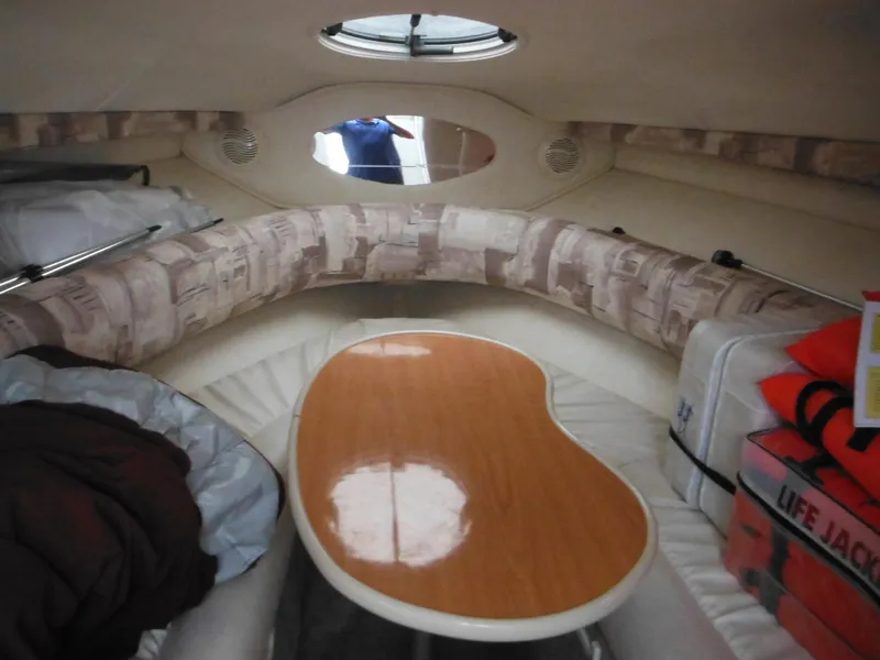 Slide: The Image of 1999 Monterey 262 Cruiser cabin interior with seating and table. - 22