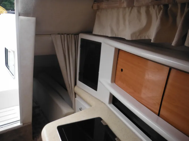 Slide: The Image of Interior cabin of a 1999 Monterey 262 Cruiser boat with storage compartments. - 23