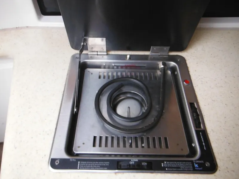 Slide: The Image of 1999 Monterey 262 Cruiser stove with coiled burner on countertop. - 24