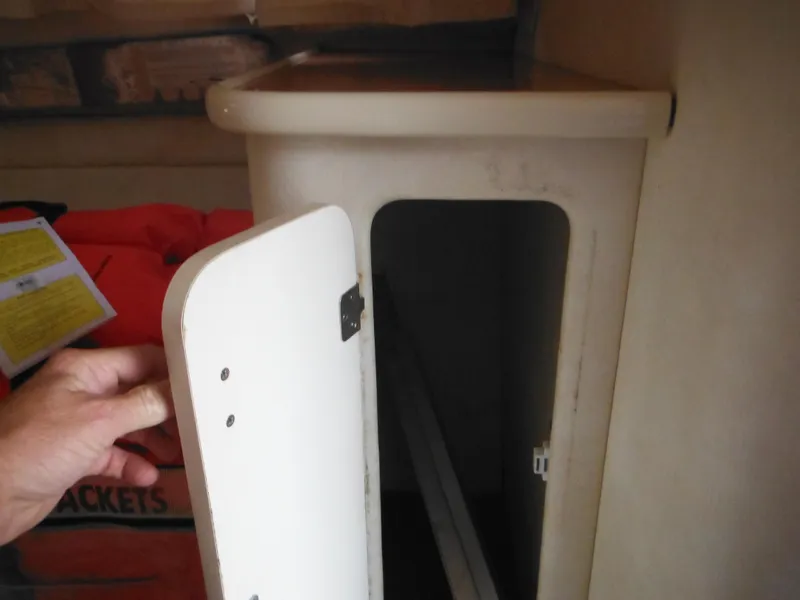 Slide: The Image of Open storage compartment on a 1999 Monterey 262 Cruiser boat. - 25