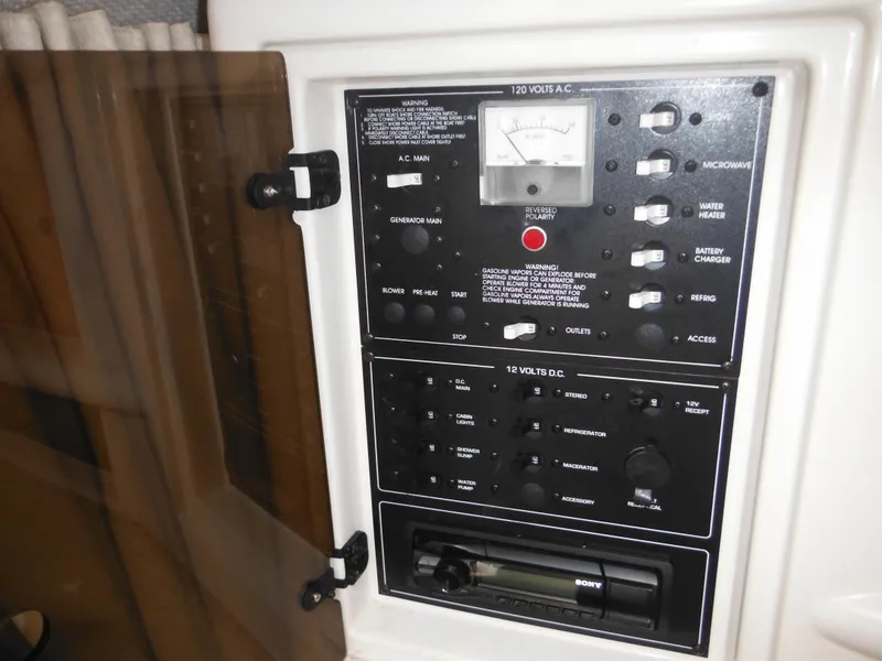 Slide: The Image of Control panel of a 1999 Monterey 262 Cruiser boat with various switches and gauges. - 29