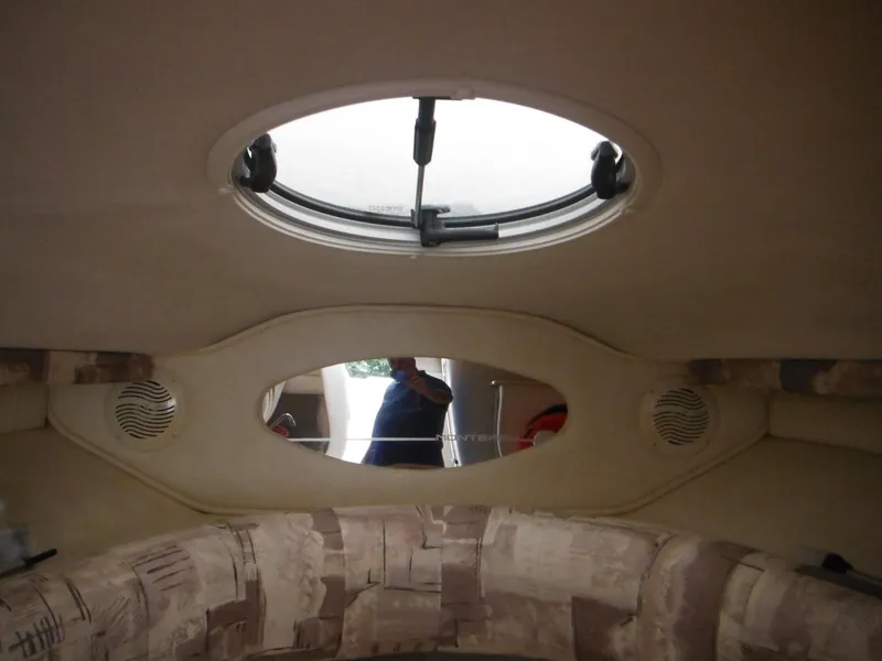 Slide: The Image of Interior cabin of a 1999 Monterey 262 Cruiser with a circular skylight. - 31