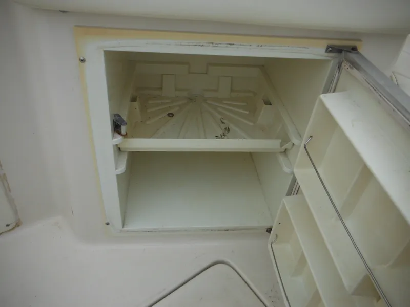 Slide: The Image of Open storage compartment on a 1999 Monterey 262 Cruiser boat. - 35