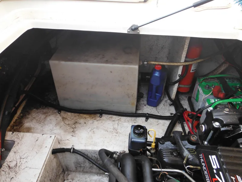 Slide: The Image of Engine compartment of a 1999 Monterey 262 Cruiser boat with visible components. - 37