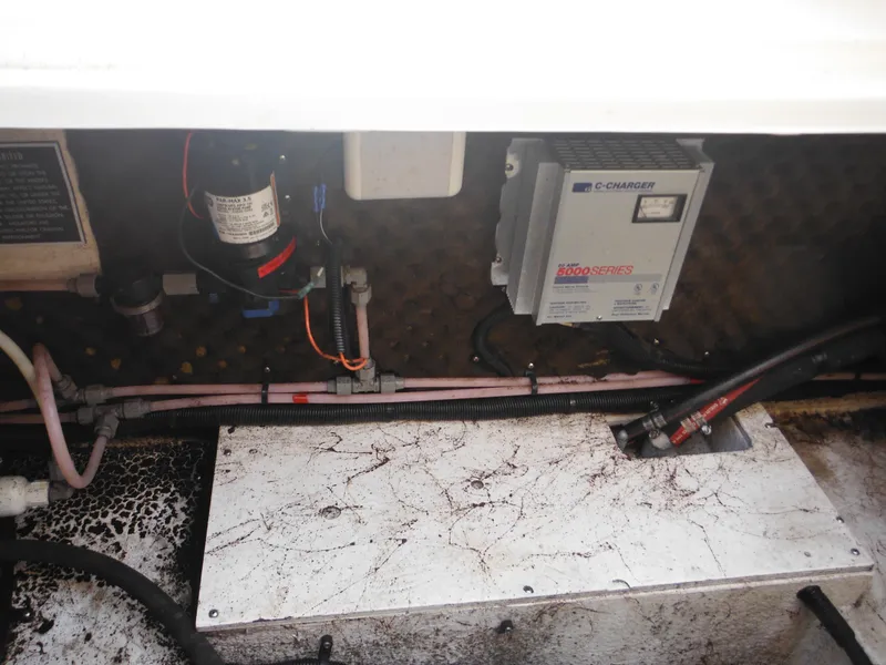 Slide: The Image of 1999 Monterey 262 Cruiser engine compartment with battery charger and wiring. - 38