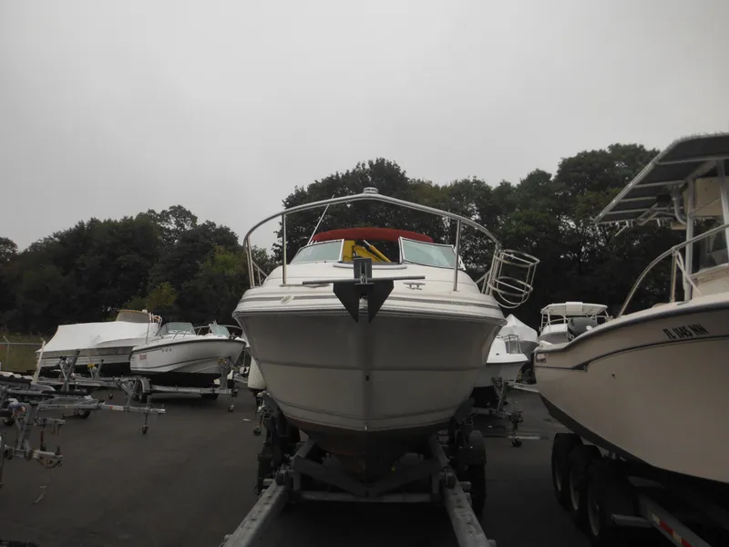 Slide: The Image of 1999 Monterey 262 Cruiser boat on a trailer in a marina. - 5