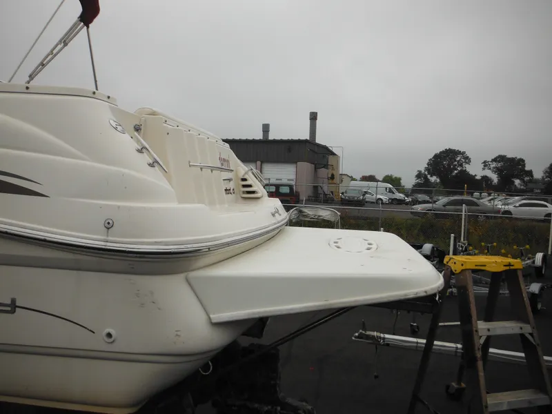 Slide: The Image of 1999 Monterey 262 Cruiser boat on trailer in a parking lot. - 8