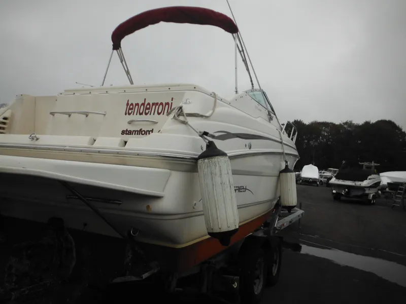Slide: The Image of 1999 Monterey 262 Cruiser boat with red canopy on trailer. - 9