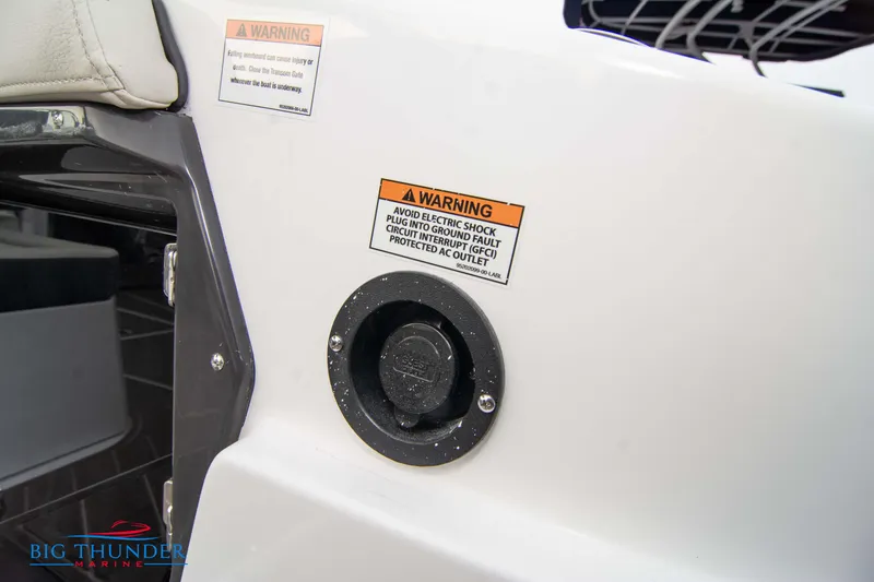 Slide: The Image of 2024 Monterey 278 SS boat with warning labels and electrical outlet. - 24