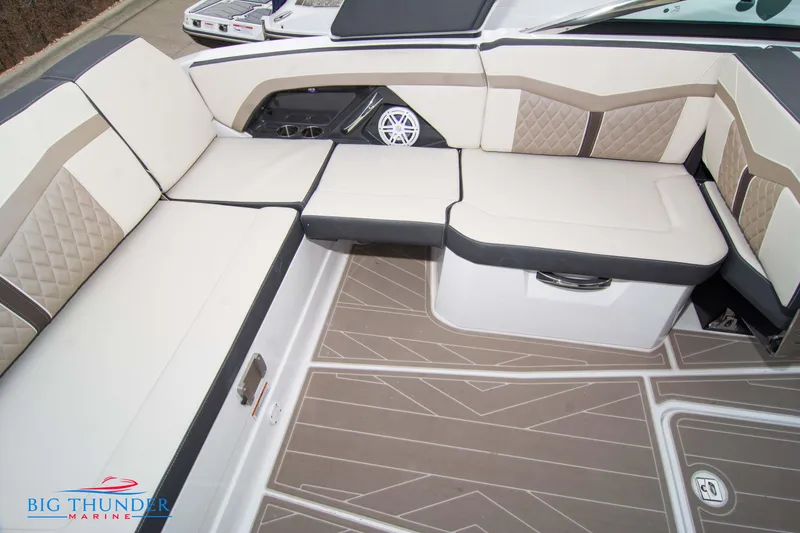 Slide: The Image of 2024 Monterey 278 SS boat interior with beige and brown seating, Big Thunder Marine logo. - 28
