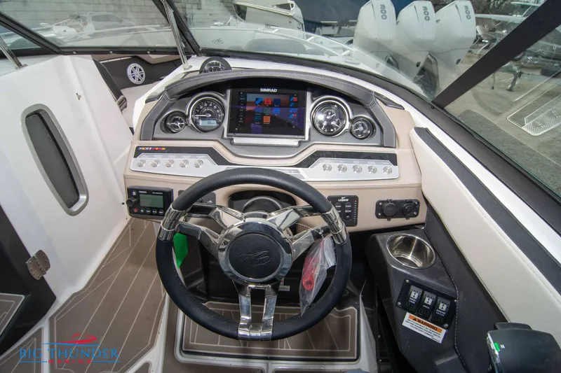 Slide: The Image of 2024 Monterey 278 SS boat dashboard with modern controls and touchscreen display. - 39