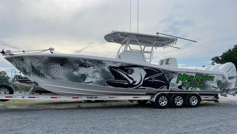Slide: The Image of 2022 Invincible 36 Open Fisherman boat with custom Mad Kingz graphics on a trailer. - 1