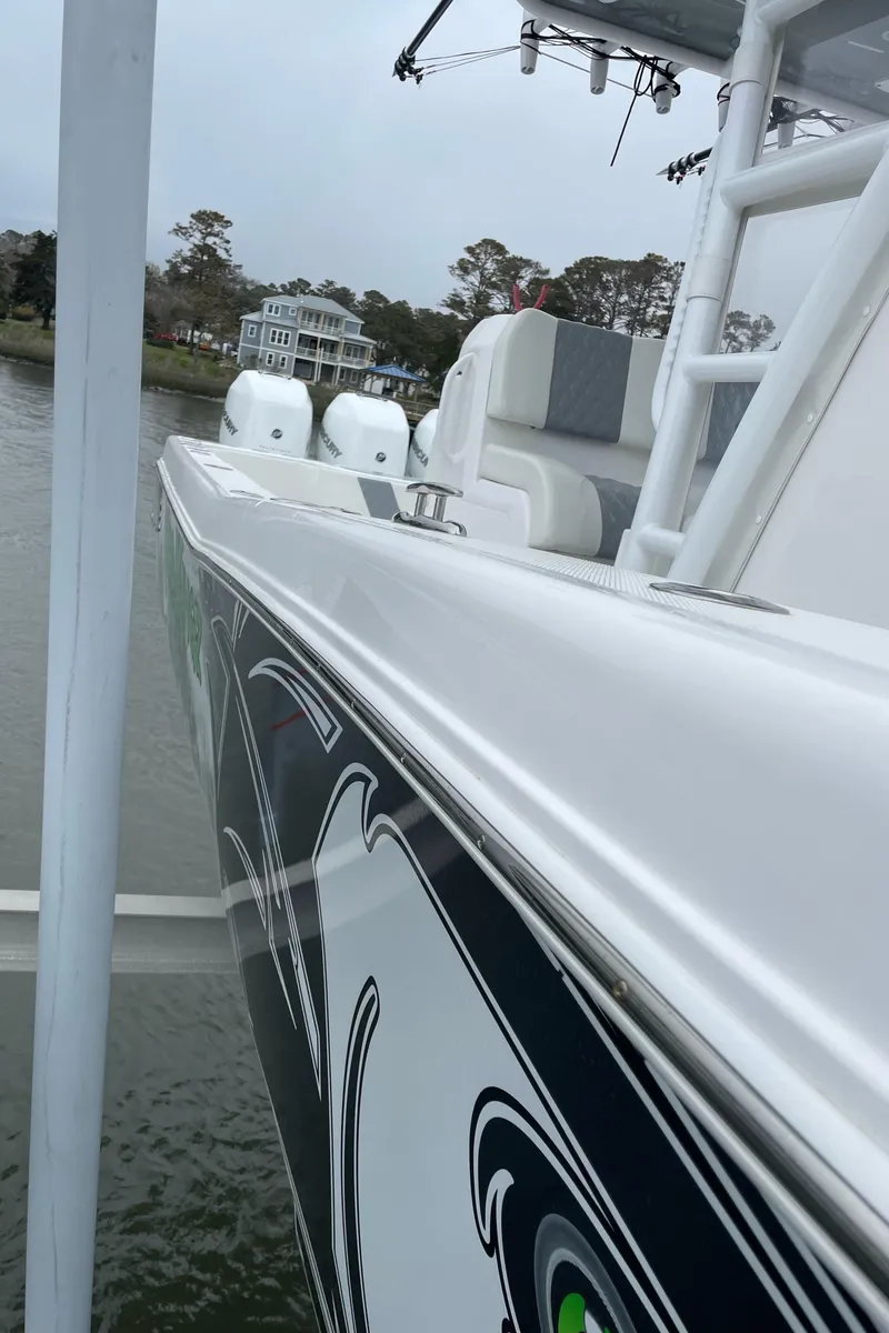 Slide: The Image of 2022 Invincible 36 Open Fisherman boat docked near waterfront homes. - 11