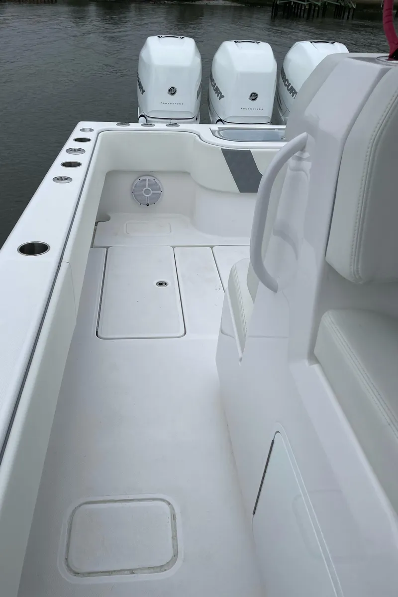 Slide: The Image of 2022 Invincible 36 Open Fisherman boat deck with triple outboard engines. - 15