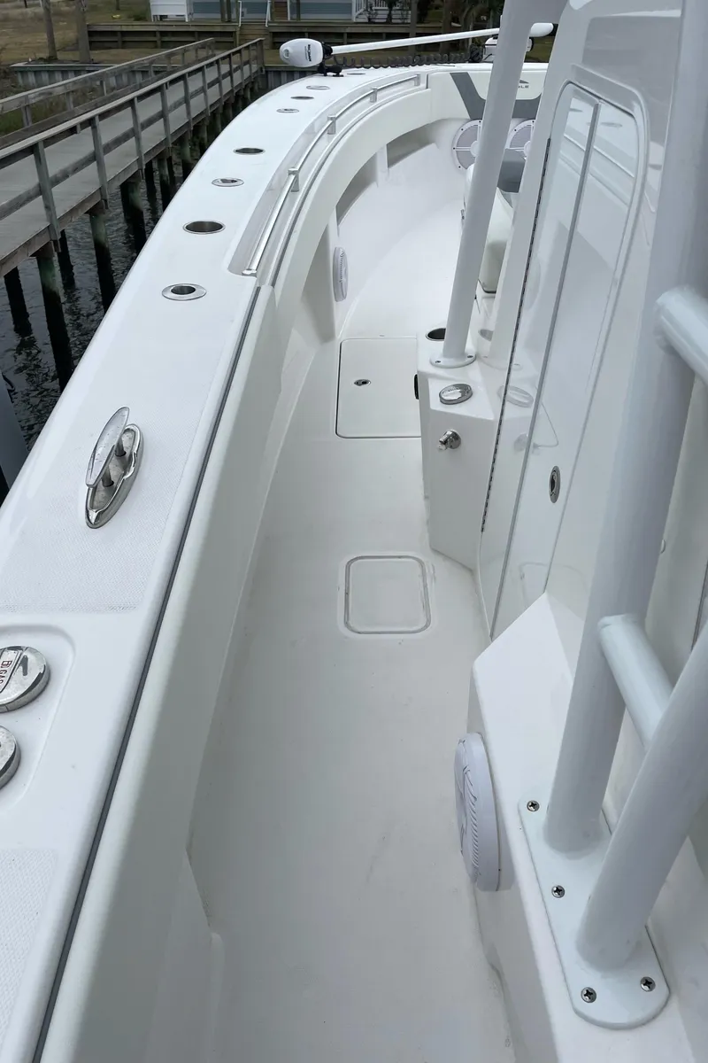 Slide: The Image of 2022 Invincible 36 Open Fisherman boat deck with rod holders and storage compartments. - 4