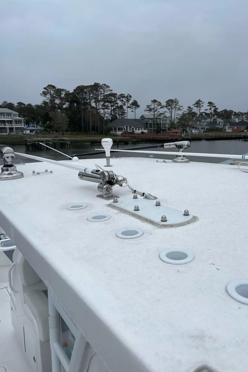 Slide: The Image of 2022 Invincible 36 Open Fisherman boat deck with coastal background. - 9