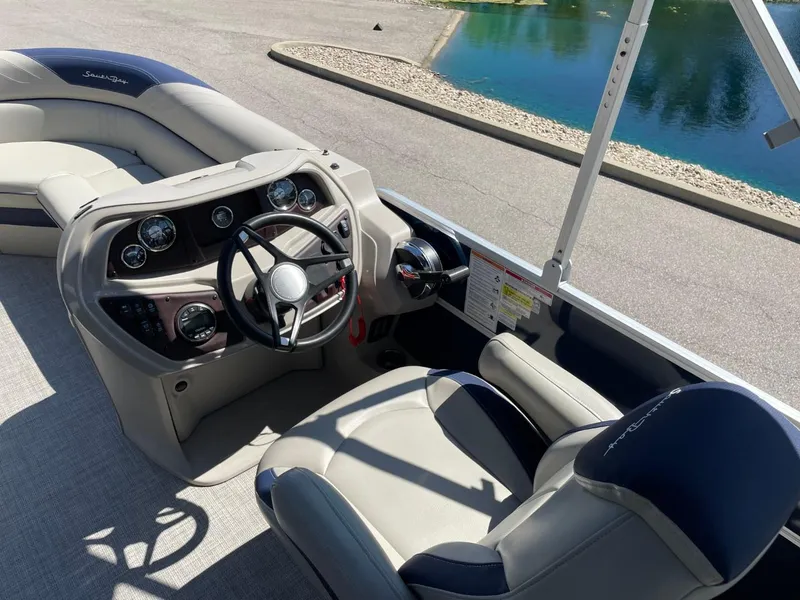 Slide: The Image of 2022 South Bay 224 RS boat interior with steering wheel and seating. - 11