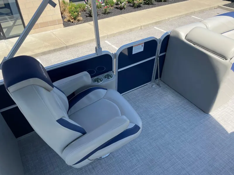 Slide: The Image of 2022 South Bay 224 RS boat interior with captain's chair and cup holders. - 12