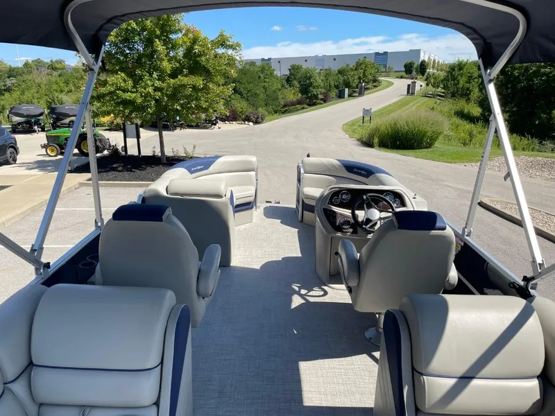 Slide: The Image of 2022 South Bay 224 RS pontoon boat interior with seating and steering console. - 14