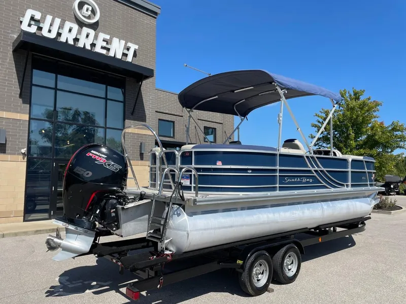 Slide: The Image of 2022 South Bay 224 RS pontoon boat on trailer outside dealership. - 3