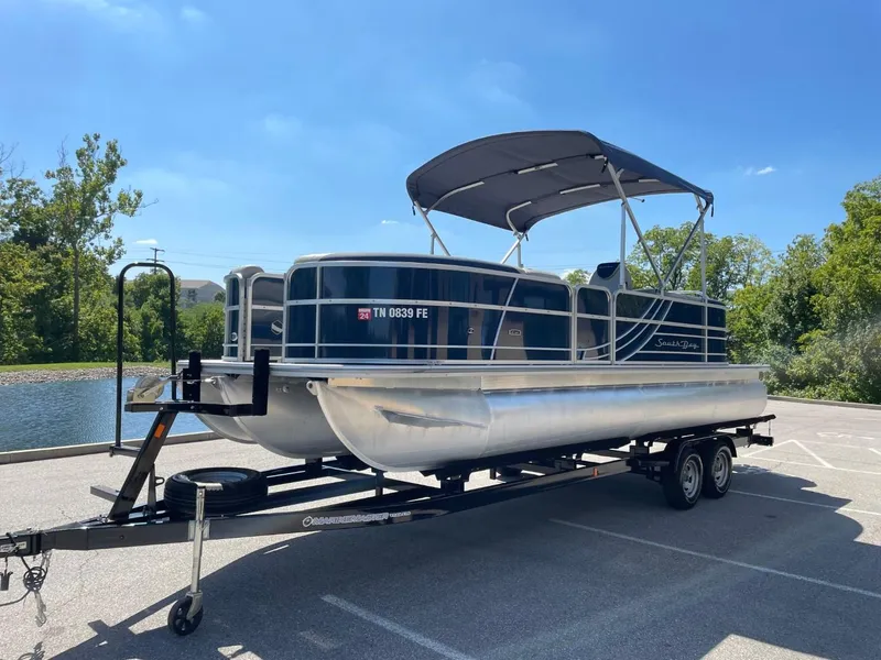 Slide: The Image of 2022 South Bay 224 RS pontoon boat on a trailer in a parking lot. - 8