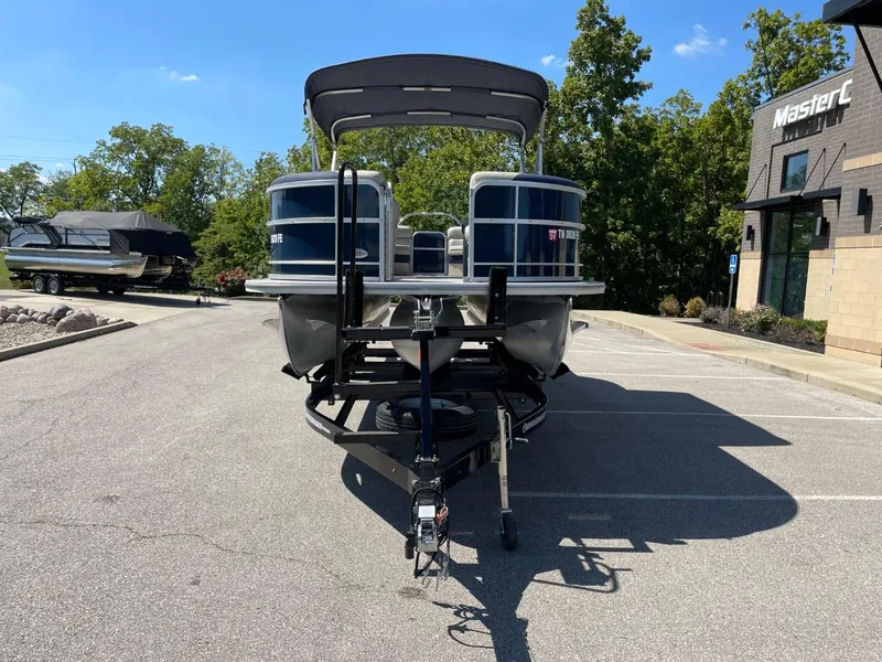 Slide: The Image of 2022 South Bay 224 RS pontoon boat on a trailer in a parking lot. - 9